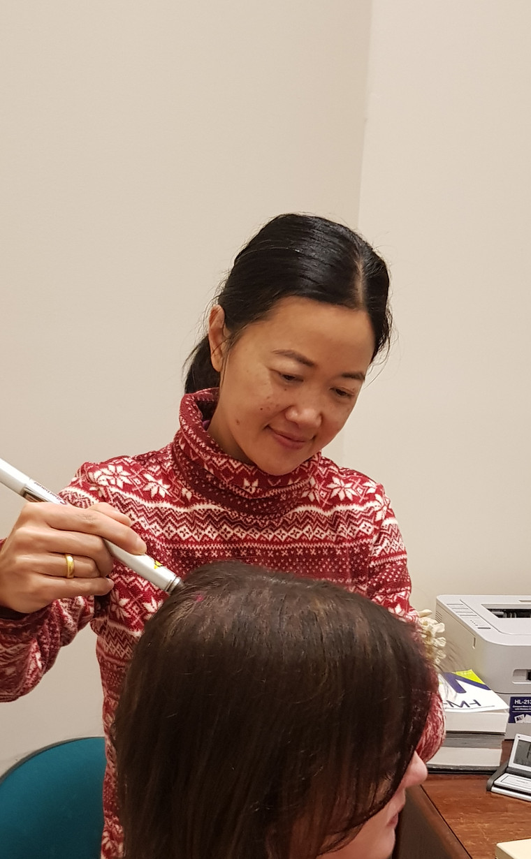 Dr Janet Hong performing laser acupuncture