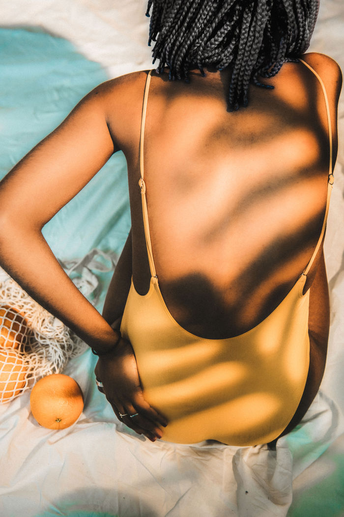 A person holding their lower back